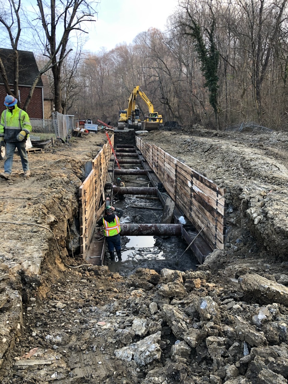 crew working on pipes in ground